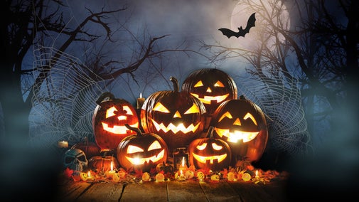 A stack of menacing looking, glowing pumpkins surrounded by a gloomy backdrop